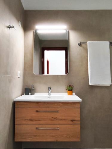 a bathroom with a sink and a mirror at Fontana 1-Bedroom House in Kavos