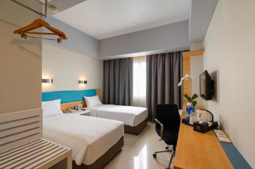 Voodi või voodid majutusasutuse BATIQA Hotel & Apartments Karawang toas