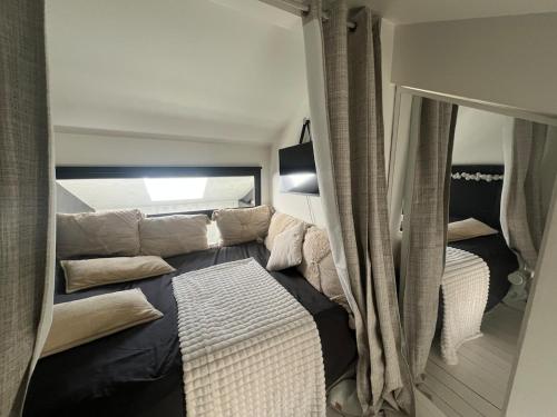 un salon avec un canapé et un miroir dans l'établissement Large unique loft, quiet and bright & outdoor, à Bagnolet