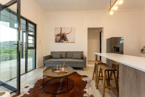 a living room with a couch and a table at Karoo Lavender in Oudtshoorn