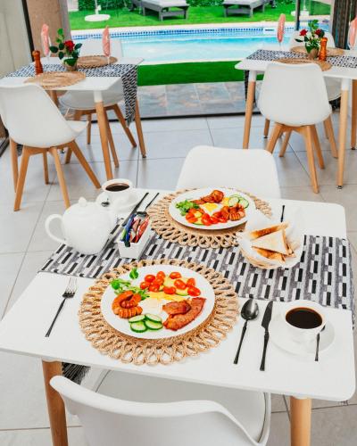 a table with two plates of food on it at Lavani Lodge in Lerulaneng