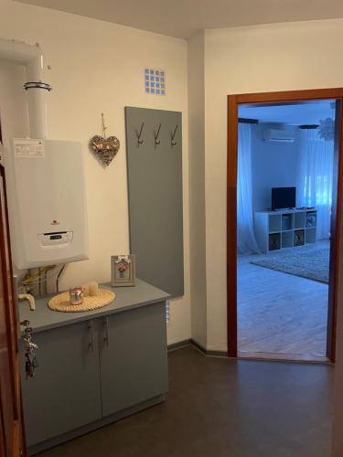 a kitchen with a counter and a door to a room at Diamant Apartmanház in Eger