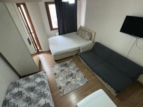 a living room with a couch and a bed at Center Hotel Two in Istanbul