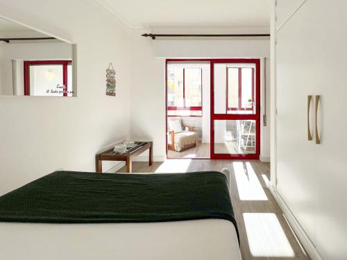 a bedroom with a bed with a green blanket at Apartment Praia Rocha Candimar Salvia in Portimão