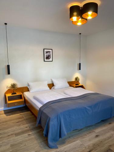 a bedroom with a large bed with two pillows at Pension Bergel in Sankt Martin