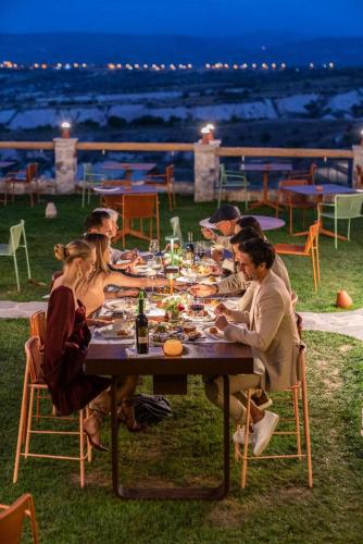 a group of people sitting at a table eating food at Taskonaklar in Uchisar