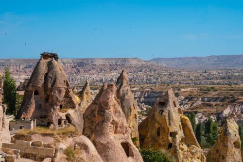 a view of a canyon with tall rock formations at Taskonaklar in Uchisar