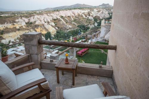a balcony with a table and chairs and a view at Taskonaklar in Uchisar