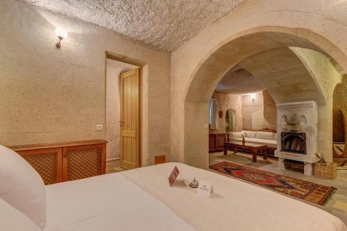 a bedroom with a bed and a fireplace at Taskonaklar in Uchisar