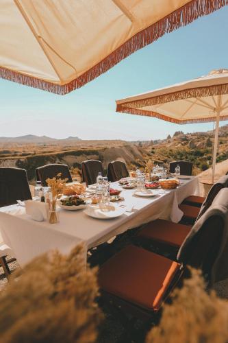 a table with plates of food on top of a mountain at Taskonaklar in Uchisar