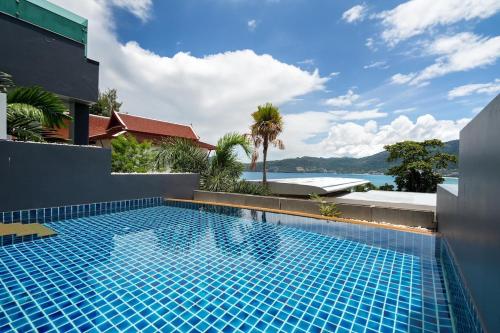a swimming pool with a view of the water at Atika Villas xero oceanfront pool villa in Patong Beach