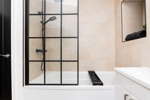 a shower with a glass door in a bathroom at 2 Bedroom Apartment-Free Parking in Hawick