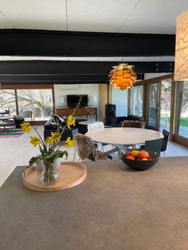 a living room with a table and a bowl of fruit at Seaside holiday home in Grenå