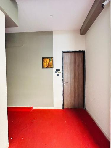 a room with a red carpet and a door at Hotel Gold Palace Inn in Surat