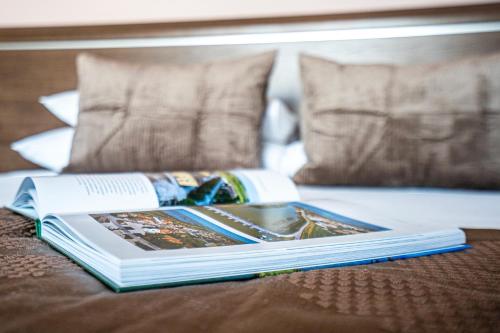 a book sitting on top of a bed at Hotel Formula Int. & Puravita SPA in Rosolina