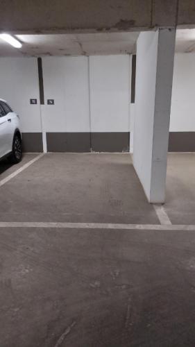 an empty parking garage with a car parked in it at Dpto Nuevo Miraflores in Santiago