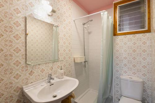 a bathroom with a sink and a toilet and a shower at El Campanar in Sant Llorenc de Morunys