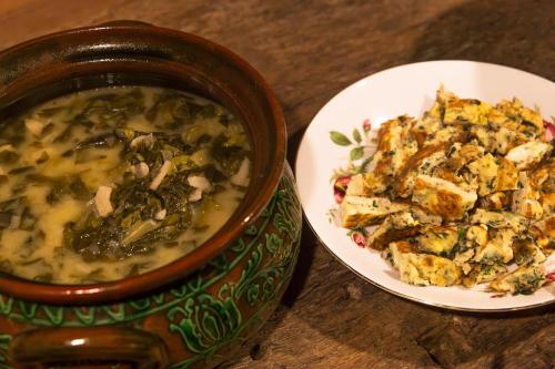 a bowl of soup next to a plate of food at Critz Cross in Criţ