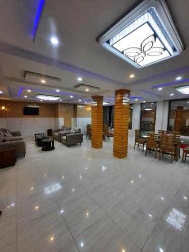 a large lobby with couches and tables and a skylight at Jan Palace Hotel Kalam Swat in Kalām