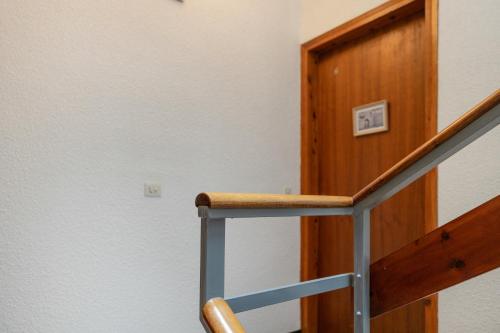 a close up of a wooden staircase with a metal railing at El Campanar in Sant Llorenc de Morunys