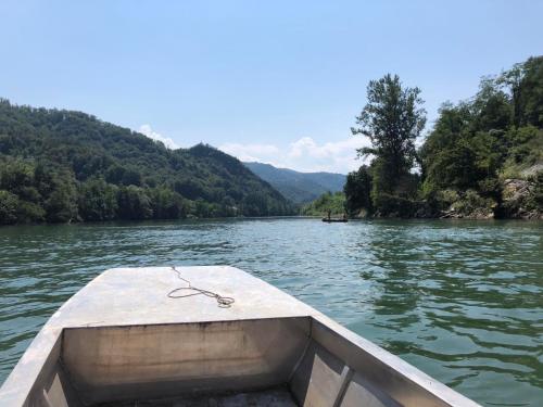 a boat in the water on a river at The Sloth - vacation home in Simići
