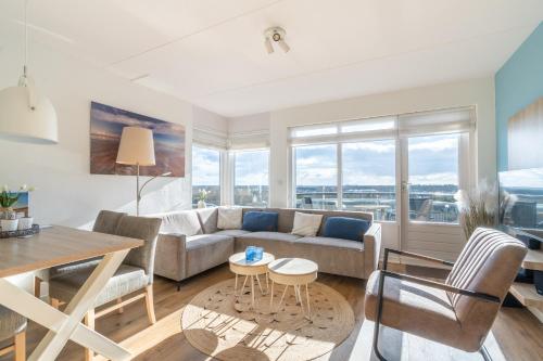 a living room with a couch and a table at Appartementencomplex Juliana 80 in De Koog
