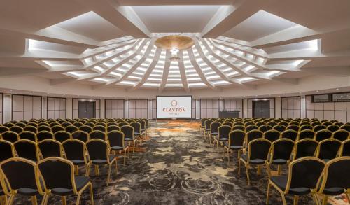 a room with rows of chairs and a stage at Clayton Hotel Düsseldorf City Centre in Düsseldorf