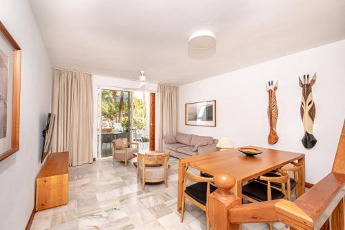 a living room with a table and a couch at Parque Santiago III Official in Playa de las Americas