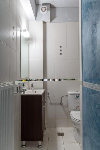 a white bathroom with a sink and a toilet at Elvita Spata Luxurious Villa in Spata