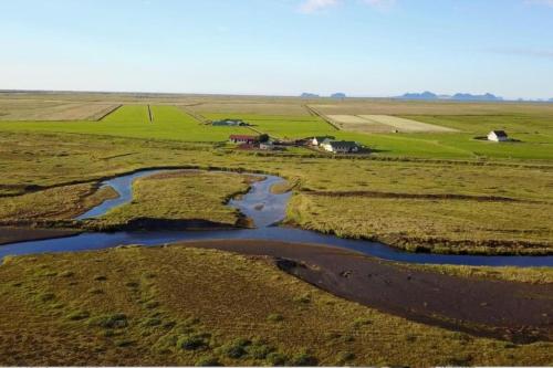 an aerial view of a river in a field at Jakob´s old farmhouse in Hvolsvöllur