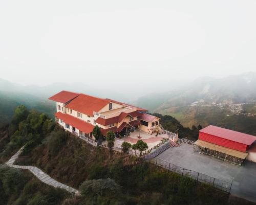an aerial view of a house on a hill at Tree of Life Highlands Mussoorie in Mussoorie