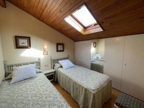 a bedroom with two beds and a skylight at Villa pour 6 à Soustons Plage avec parking privé - FR-1-379-116 in Soustons