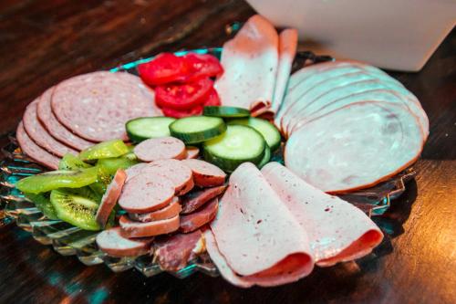 a plate of meats and vegetables on a table at The Residence at Villa Wiese in Swakopmund