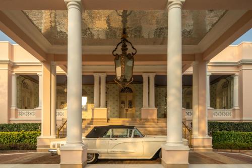 a white car parked in front of a building at Rajmahal Palace RAAS in Jaipur