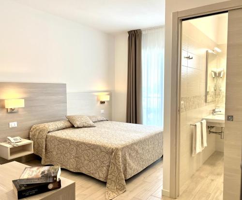 Postel nebo postele na pokoji v ubytování Hotel Milano