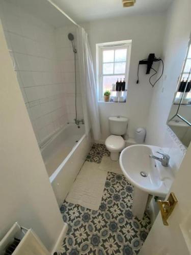 a bathroom with a toilet and a sink at 3 Bed House - Sleeps 6 - Parking - Wifi in Maidstone