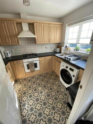 a small kitchen with a stove and a sink at 3 Bed House - Sleeps 6 - Parking - Wifi in Maidstone