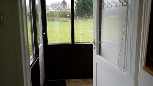 an open door with a view of a field at Amalia in Nes