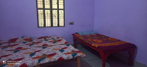 Un dormitorio con dos camas y una ventana. en JMS Girls Hostel, en Varanasi