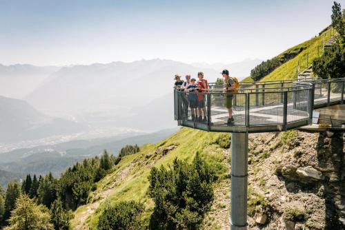 a group of people standing on a viewing platform on a mountain at Panorama Apartment Imst in Imst
