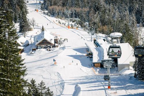 a ski slope with people on a ski lift at Panorama Apartment Imst in Imst