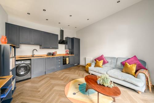 a living room with a couch and a table at The Signal Station Luxury Aparthotel in Edinburgh