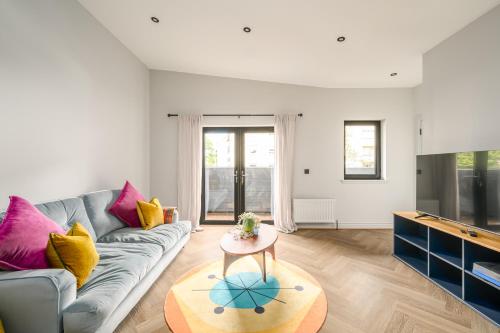 a living room with a couch and a table at The Signal Station Luxury Aparthotel in Edinburgh