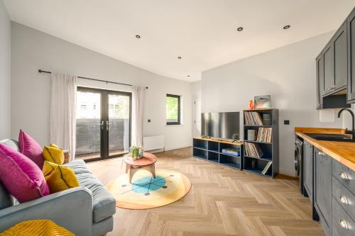 a living room with a couch and a table at The Signal Station Luxury Aparthotel in Edinburgh