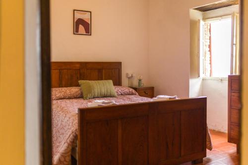 a bedroom with a bed and a mirror at Casa Falerno in Città di Castello