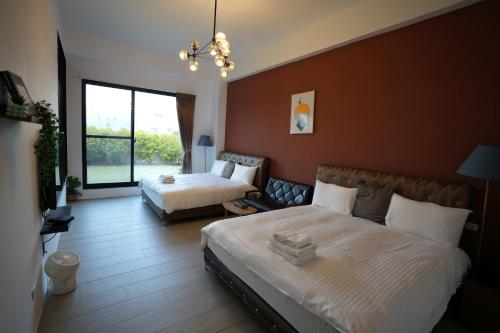 a hotel room with two beds and a window at Easyinn in Hengchun
