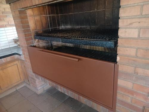 a brick oven with a grill inside of it at BauHouse Comfort Suites Asuncion in Asuncion