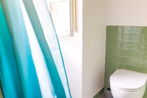 a bathroom with a toilet and a window at Casa Falerno in Città di Castello