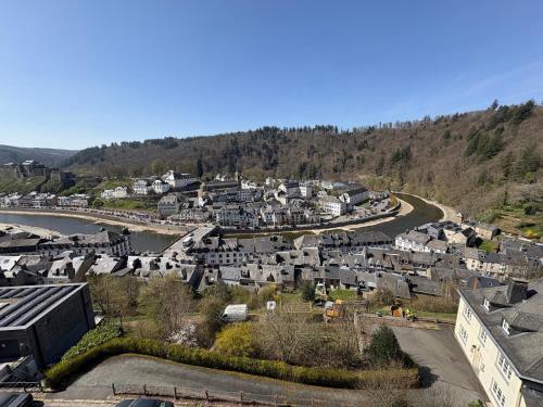 an aerial view of a town next to a river at Hôtel Panorama - Vue exceptionnelle sur la Semois in Bouillon