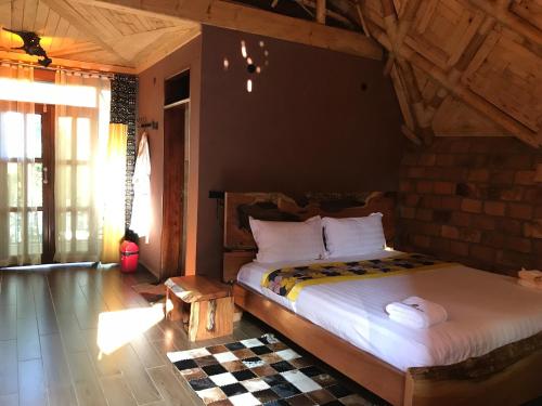 a bedroom with a large bed in a room at Masaka Cultural Resort in Masaka
